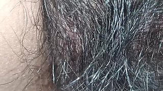 Close up view on a hairy and creamy pussy