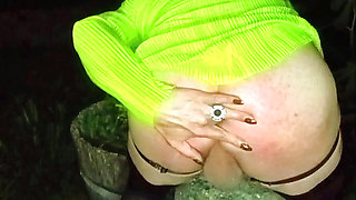 Pretty sexy mature transvestite slut shows off outdoors with a cigarette and high heels