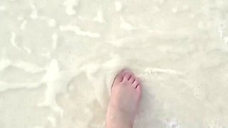 Running My Bare Feet on the White Beach Sand by the Ocean