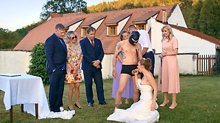 A man in a dog mask is fucking the bride while outside