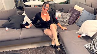 Busty mature cougar Erika Preziosi shows off nylons and stilettos in the furniture store