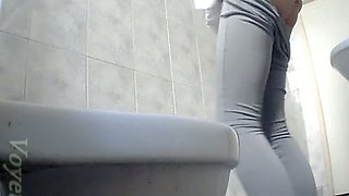 Lean and sexy white stranger girl filmed from behind in the toilet