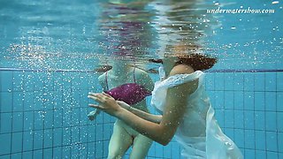 Attractive hotties Sima Lastova and her girlfriend strip under the water