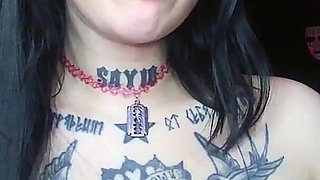 Sexy Alternative Brunette Drinking Sparkling Water and Burping