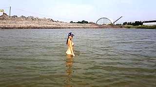 Naked girl masturbates on the river shore