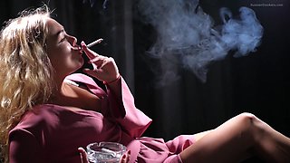 Blonde Girl Is Smoking A Cigarette Is The Dark Room