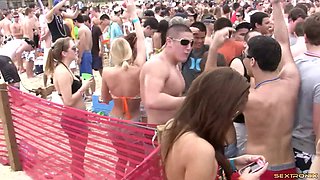 Dance party on the beach with lots of hotties in bikinis
