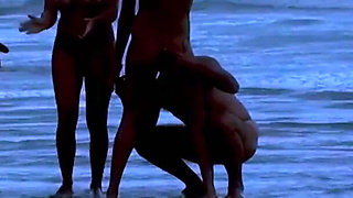 Big ass on the beach with several naked women having sex