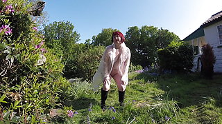 Flashing in the garden in plastic coat and boots