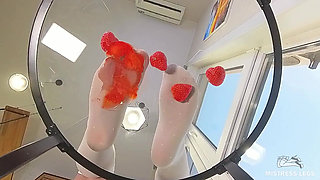 My Nylon Feet Squeezing Strawberry Juice on a Glass Table