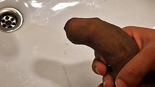 He pisses in the sink with his huge cock