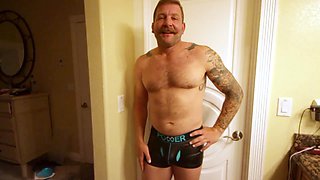 Unshaved beefcake Colby Jansen flaunts his huge dildo collection