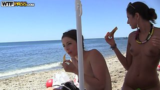 Slim brunette chicks boast of their small tits right on the nudist beach