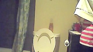 Hidden piss cam in the home toilet shows peeing sister