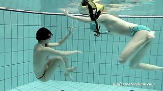 girls swimming underwater and enjoying eachother