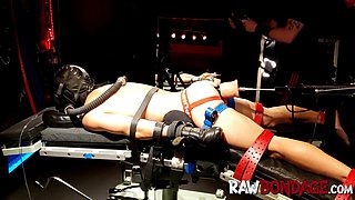 Shackled jock lounging face down being fisted in his bum
