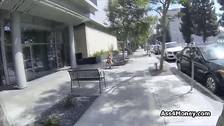 Barista blows in public parking lot at day