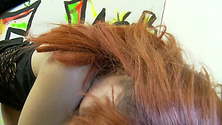 Redhead with big tits sucks dick through a glory hole