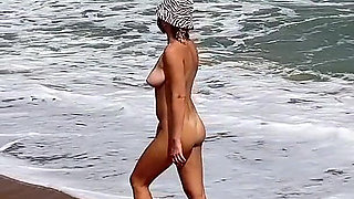 A Busty Blonde Is Walking and Sunbathing Naked