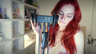 Redheaded pierced teen close up toy show