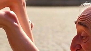 Submissive Man Worshipping Mistress Feet in Public Plaza