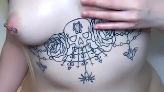 amateur tattooed blonde oils her pierced tits