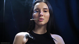 Elegant Brunette Smoking in Black Outfit