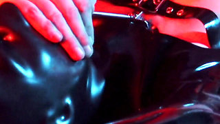 Heavy rubber masked latexgirl stretched and tickled
