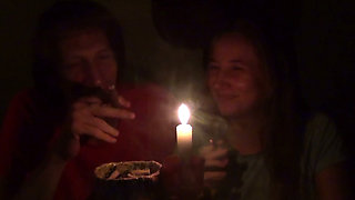 Couple Smoke Next to Candle