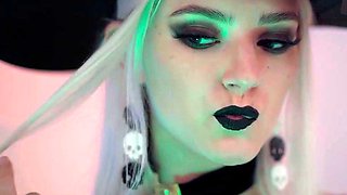 A blond doll in a witch hat and black with cum