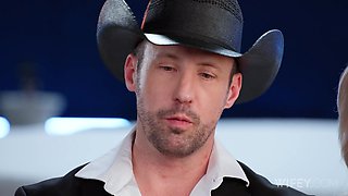 Hot blonde milf enjoys playing with her black friend's huge cock, sucking and riding it, while her boyfriend is watching her fun, sitting on the couch