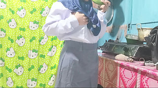School girl masturbates in the kitchen using cucumbers