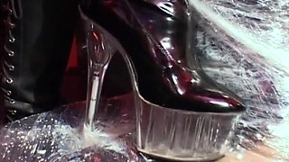 Cute filn-coated babe gets her pussy fucked by couple of strict mistresses in black