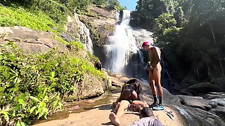 Black hottie got her holes busy with two cocks on a waterfall