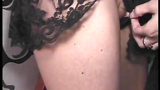 Leather clad dominatrix flogging and working her slaves nipples