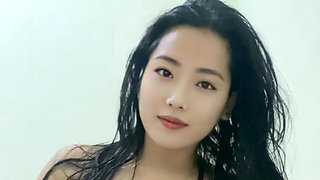 A young mother with big breasts, wearing a sexy outfit after a shower looking incredibly alluring.
